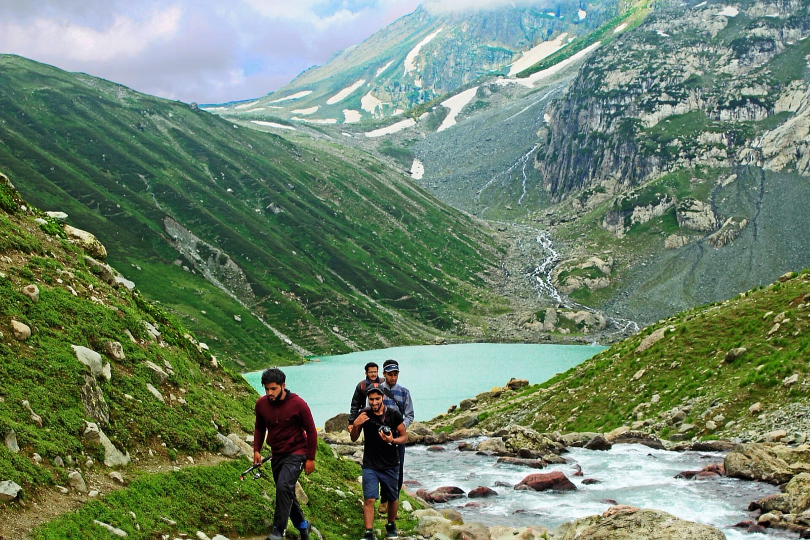 A small group walking a ridge line in single file